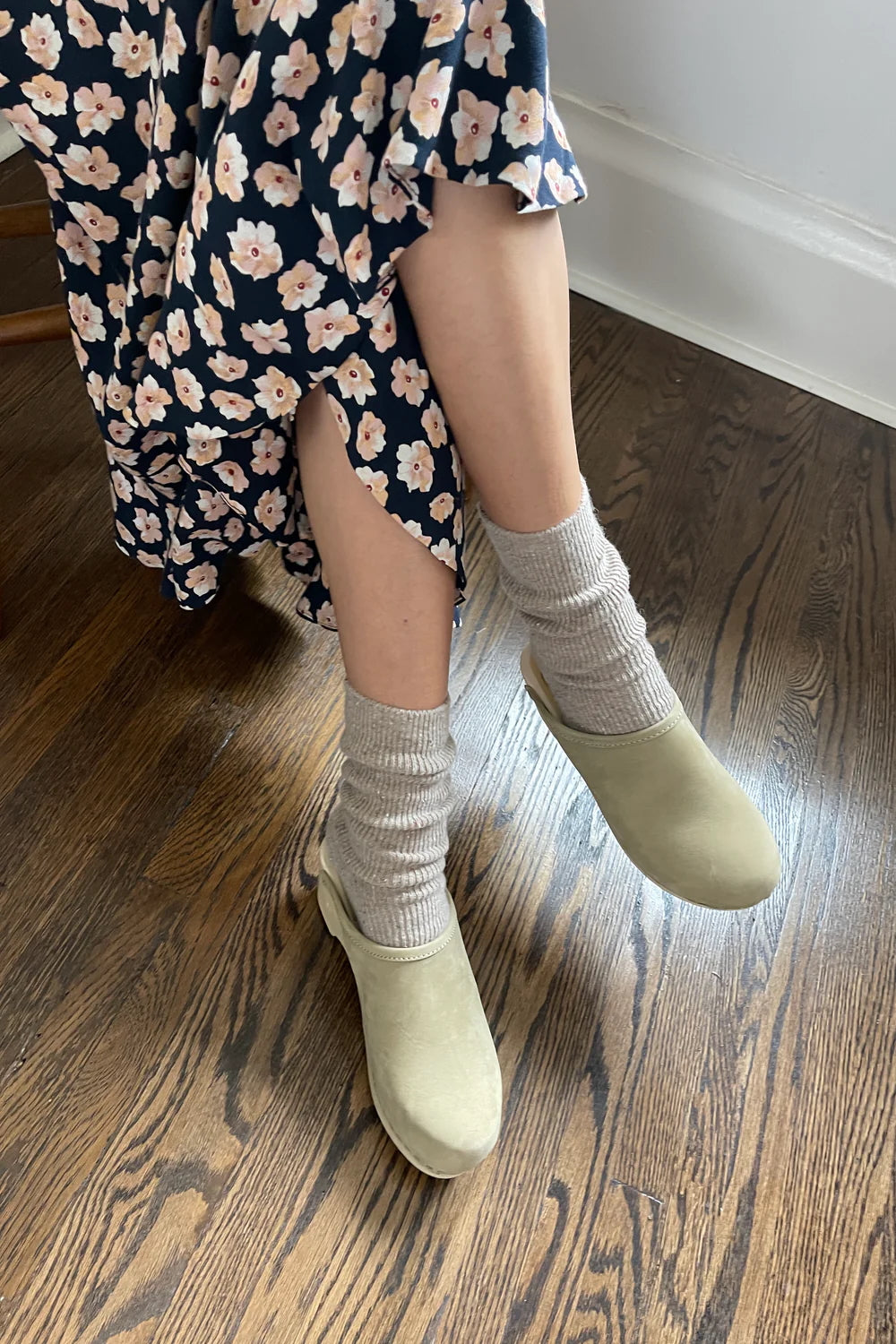 woman in floral dress in cozy beige socks