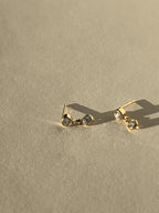 Close-up product shot of Thalken’s 3mm gold-filled cubic zirconia stud and drop earrings on a neutral background, highlighting the bezel setting and drop