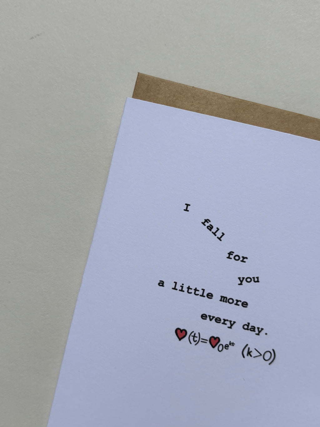 Greeting card reading “I fall for you a little more every day,” featuring a symbolic equation inspired by the continuous growth model, with the words “I fall for you” arranged to appear as if they’re gently falling.