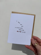 Greeting card held in hand reading “I fall for you a little more every day,” featuring a symbolic equation inspired by the continuous growth model, with the words “I fall for you” arranged to appear as if they’re gently falling.