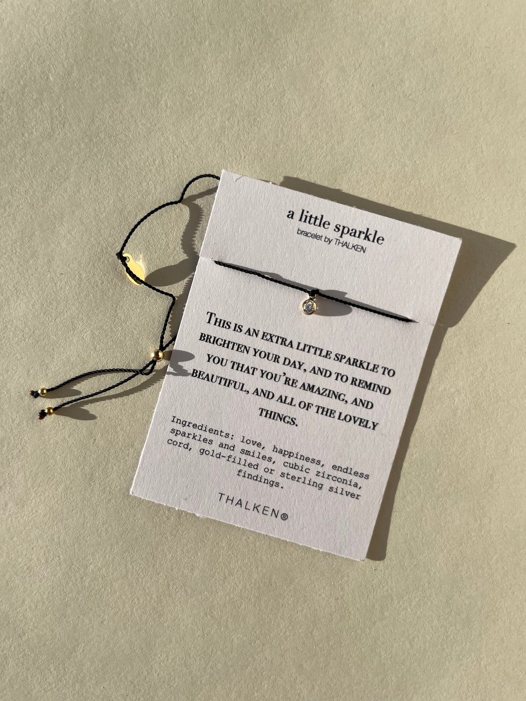 Thalken® sparkle mantra bracelet displayed on a bracelet card with the written intention and meaning