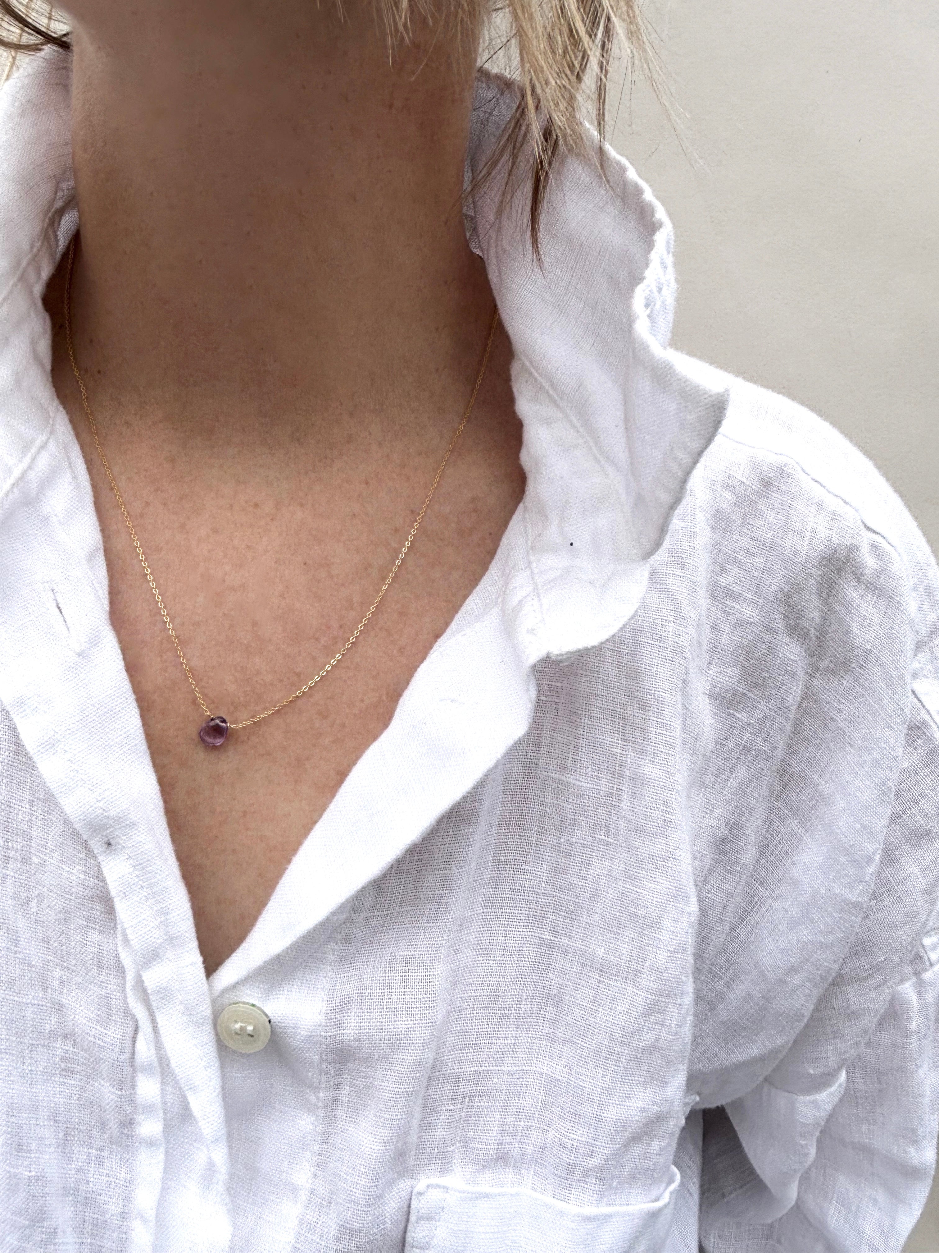 Dainty Thalken amethyst drop necklace on woman wearing white linen button down shirt