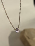 Natural purple amethyst drop stone fixed on dainty yellow gold-filled chain suspended in air