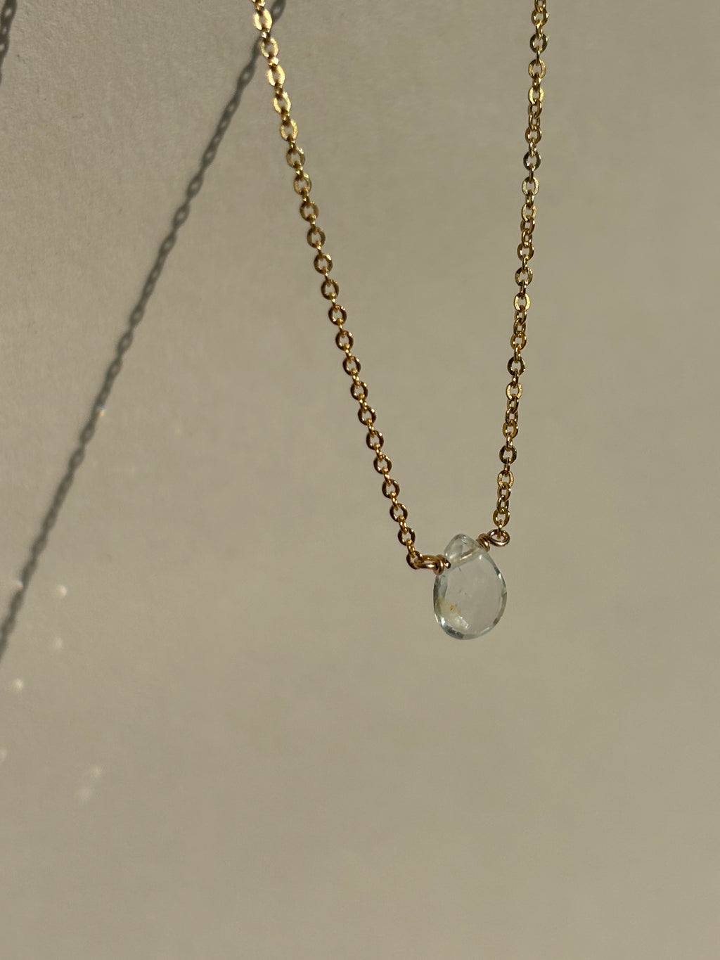 Natural blue aquamarine drop necklace in yellow gold-filled suspended in air