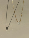 Light blue aquamarine stone necklace in yellow gold-filled suspended in air with sparkly light