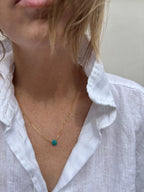 Model wearing dainty Arizona turquoise drop necklace in yellow gold-filled