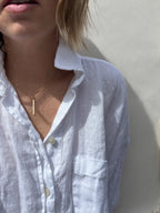 Model wearing minimalist Thalken bar necklace in the 16" option
