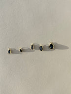 Assorted Thalken 14k gold single drop earring charms in pear, marquise, and oval shapes, displayed unattached to hoop earrings