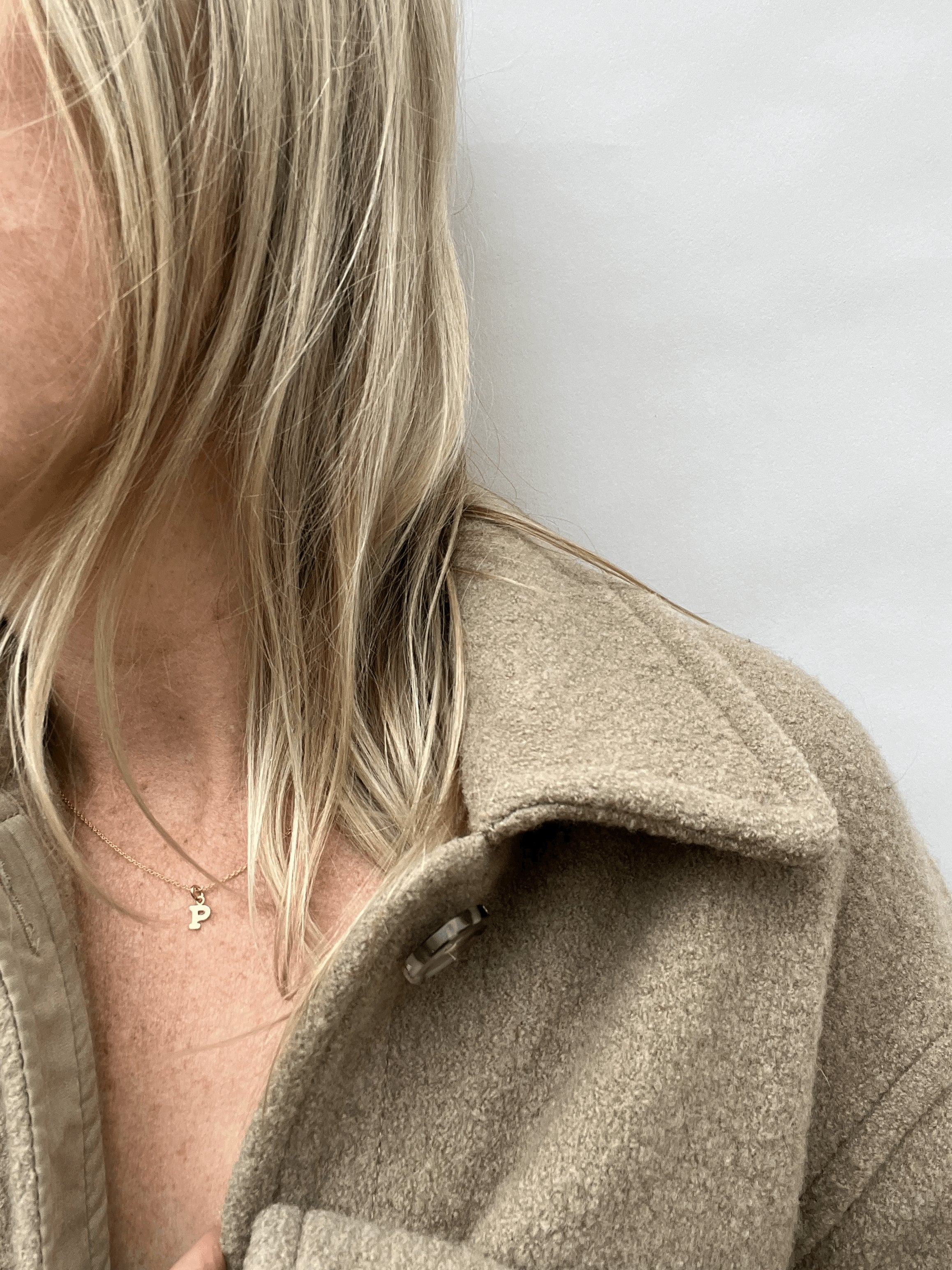 Model is wearing the yellow gold-filled 18" Block Letter Charm Necklace with the letter “P” option