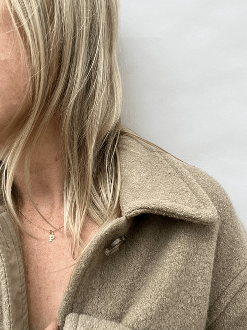 Model is wearing the yellow gold-filled 18" Block Letter Charm Necklace with the letter “P” option