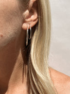 Close-up of model showing 35mm and 24mm sterling silver hoops in first and second ear piercings