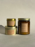 Three Thalken Fancy Folks Wearing Sweaters candles in small and medium gold tins and a large brown glass jar