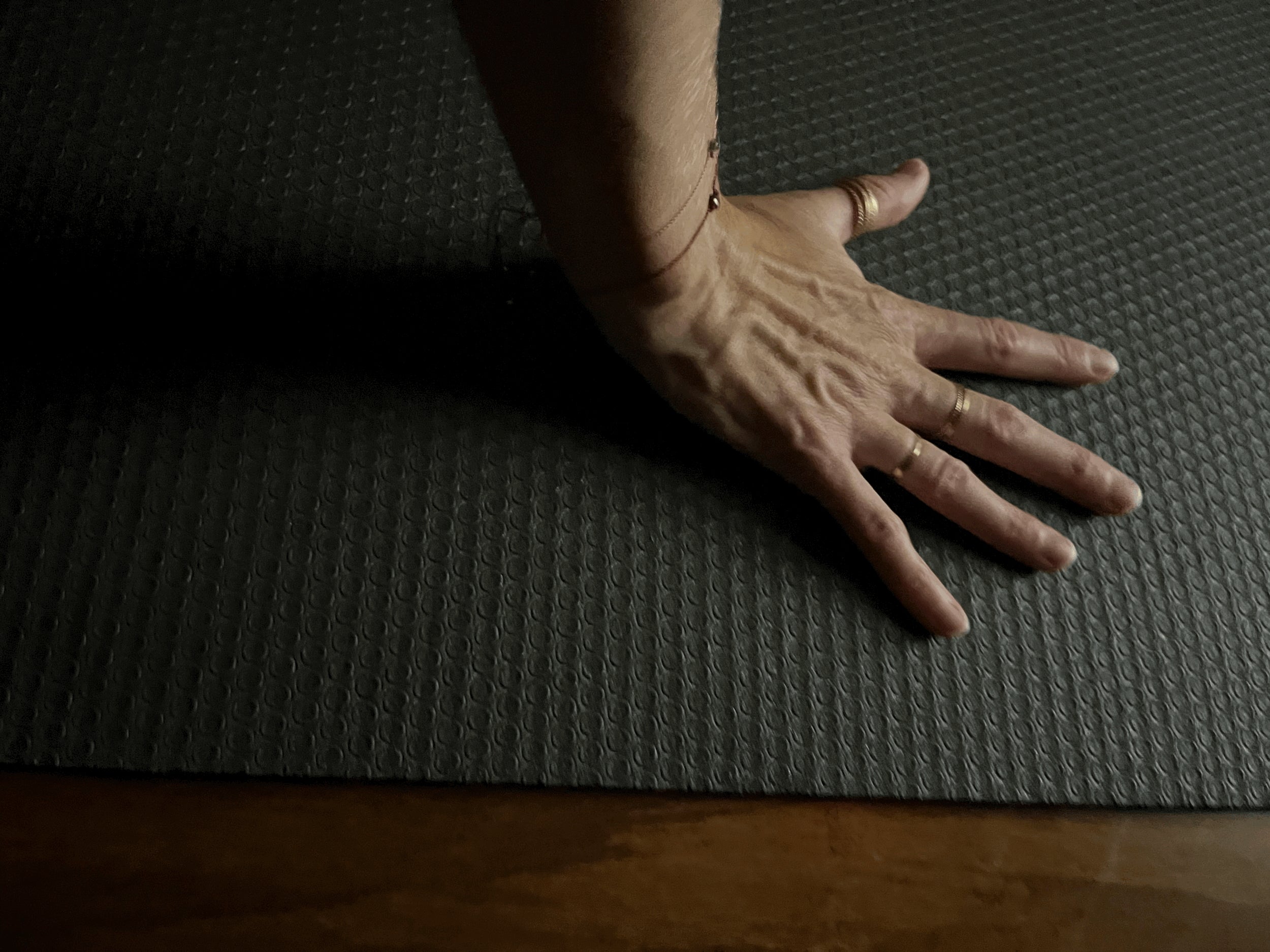 Thalken® Herkimer Diamond bracelet stacked with Thalken® My Energy Is Sacred bracelet, worn on wrist braced on a yoga mat