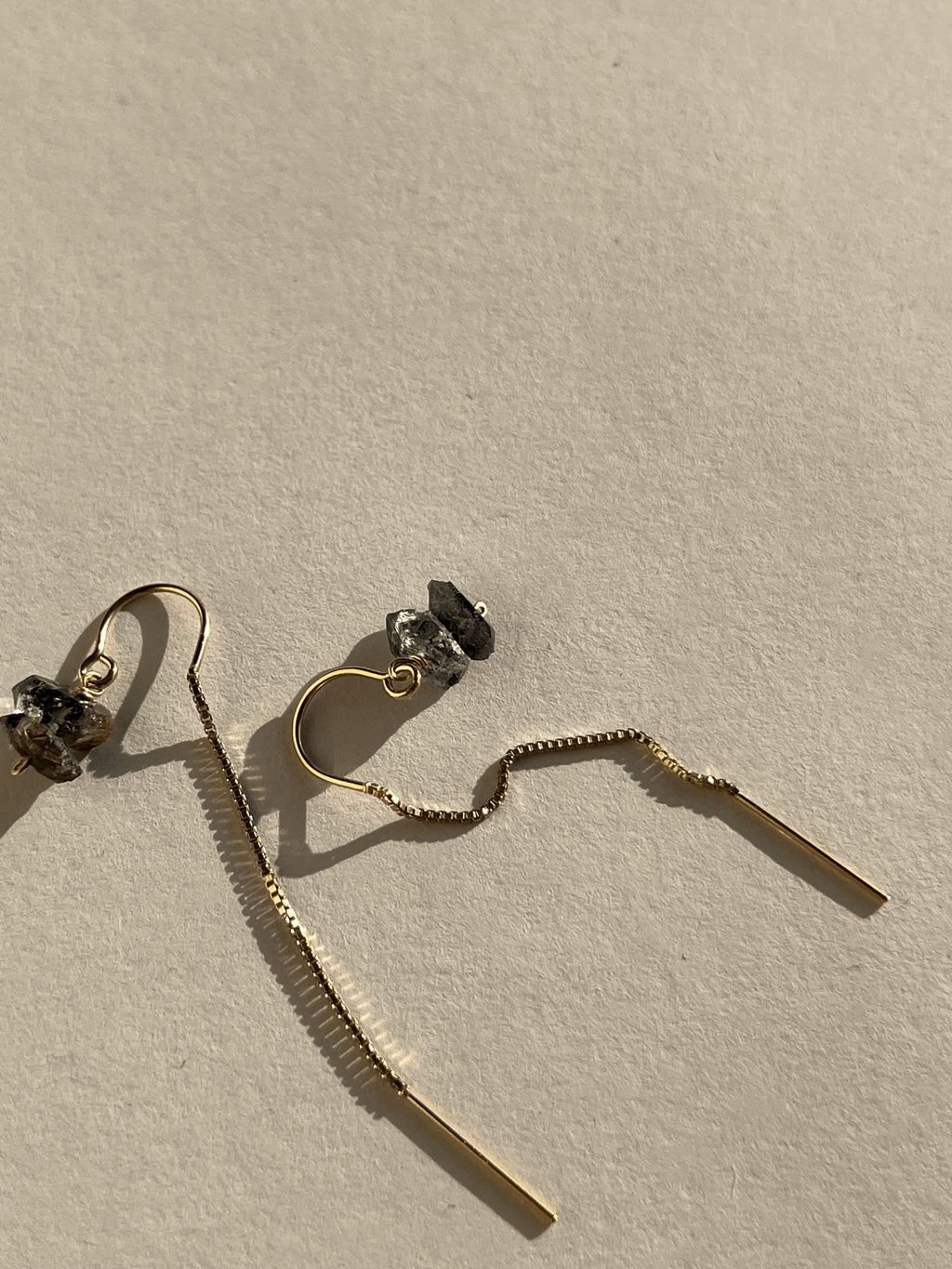Pair of yellow gold-filled Herkimer Diamond Threader Earrings displayed flat on a neutral backdrop, showcasing the U-threader backs and four natural crystals