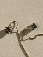 Extreme close-up of a Herkimer diamond showing double-terminated points and natural inclusions, set on a yellow gold-filled U-threader