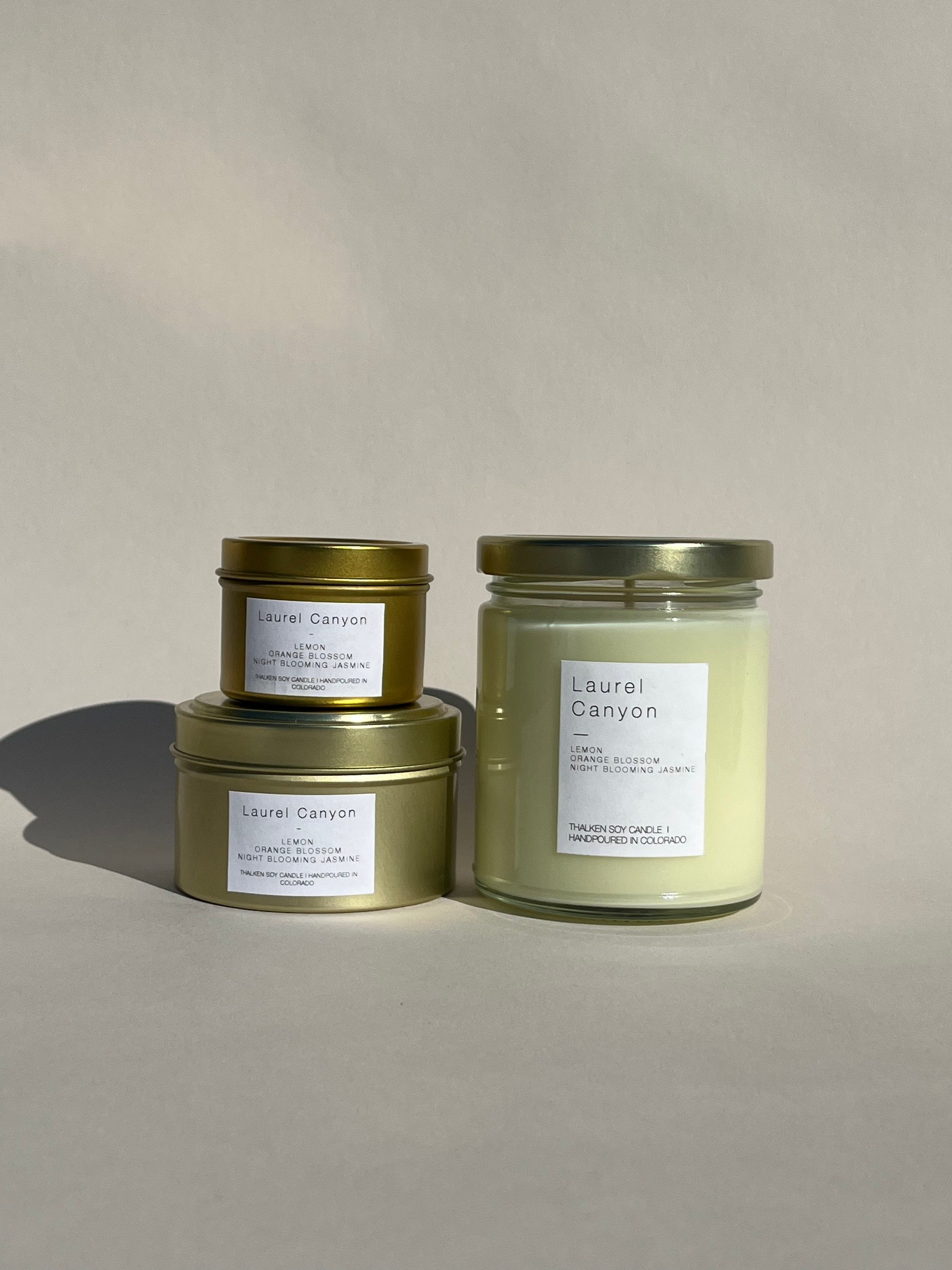 Thalken® Laurel Canyon candles in three sizes — 2oz and 6oz gold tins and 8oz soft-glow glass jar. Scent profile: sweet and intoxicating notes of lemon, orange blossom, and night-blooming jasmine