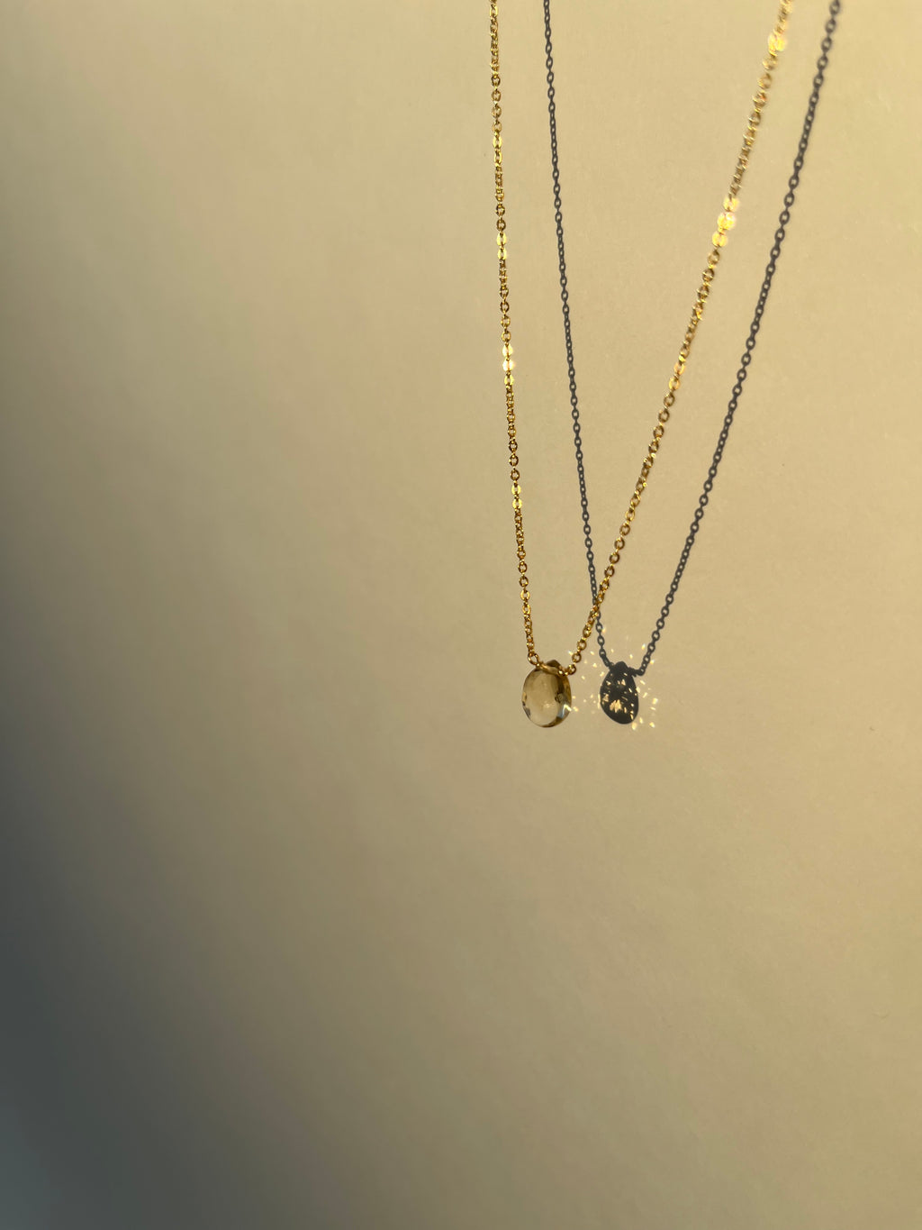 Product shot of citrine drop necklace suspended in air