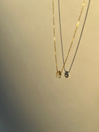 Product shot of citrine drop necklace suspended in air