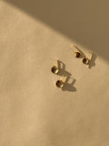 Overhead product shot of yellow gold-filled Minimalist Disc Dangles arranged side by side, showcasing the two disc sizes and elegant wire hooks