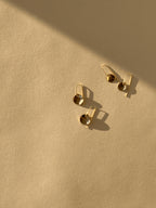 Overhead product shot of yellow gold-filled Minimalist Disc Dangles arranged side by side, showcasing the two disc sizes and elegant wire hooks