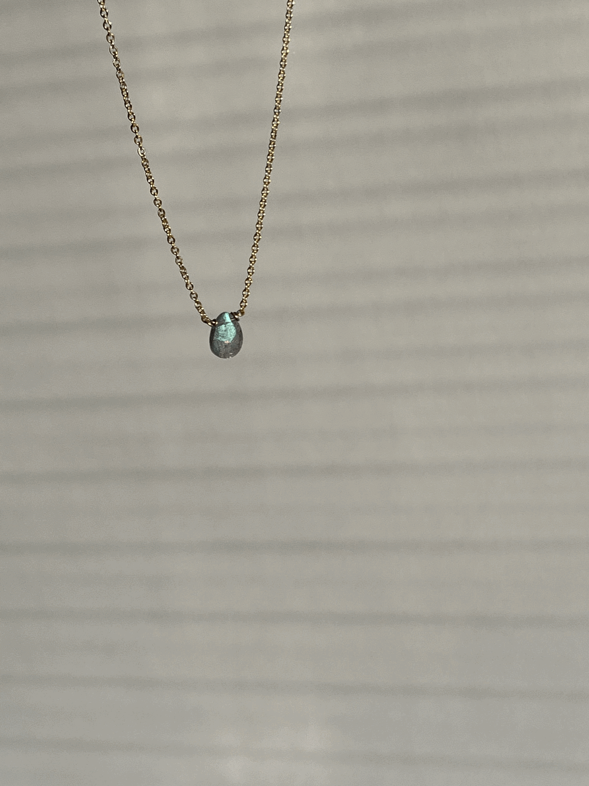 Yellow gold-filled dainty labradorite drop necklace suspended product shot by Thalken