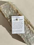 Close-up of the Moon Charged bracelet on its mantra card, highlighting the mother-of-pearl bead and cord details