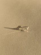 Pair of sterling silver moon stud earrings shown on a light backdrop