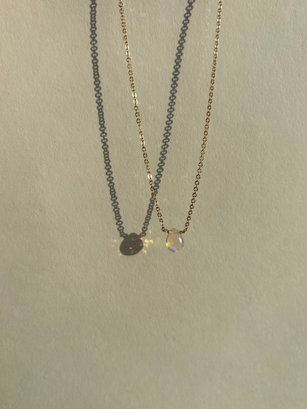 Real Ethiopian opal drop set in the center of a dainty yellow gold-filled chain by Thalken