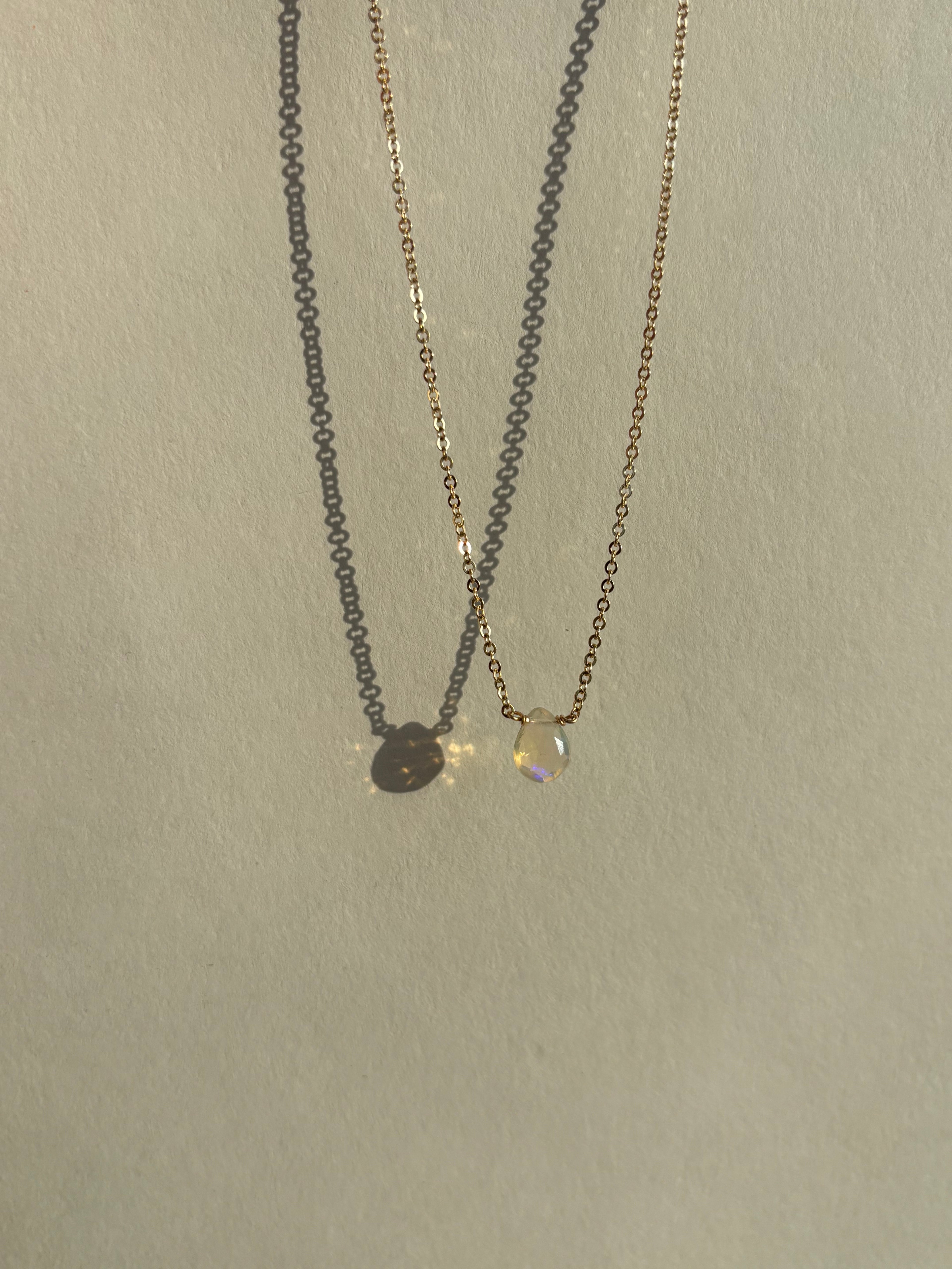 Real Ethiopian opal drop set in the center of a dainty yellow gold-filled chain by Thalken