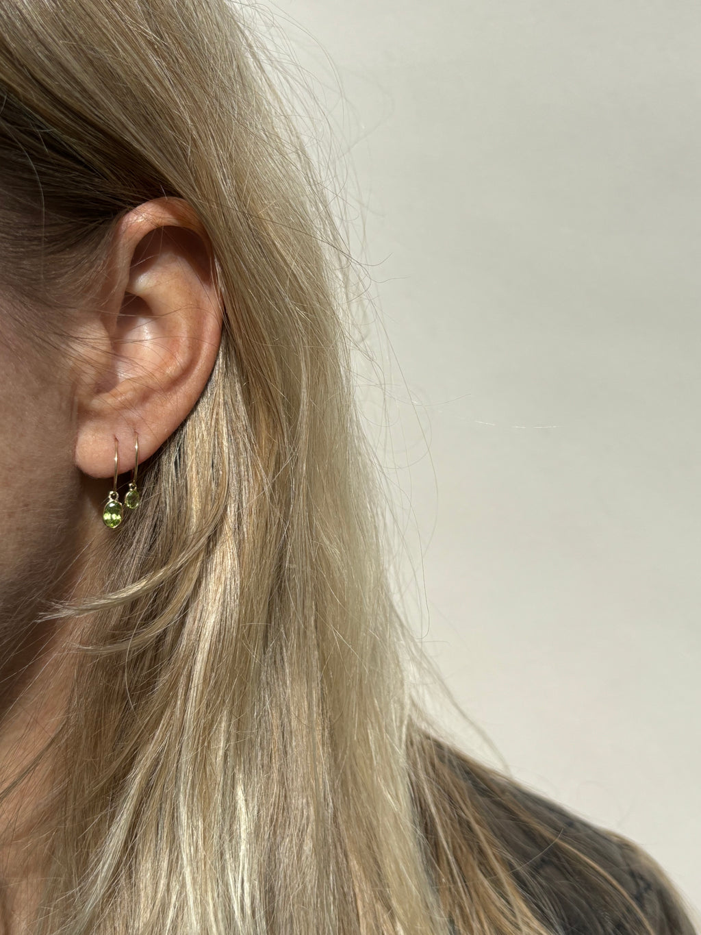 Model wearing a 12mm hoop with the medium oval drop in her first ear piercing, and a 10mm hoop with the small oval drop in her second ear piercing
