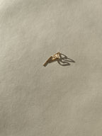 Petite Heart Drop-Back Earrings displayed on a neutral background, featuring a minimalist heart front and the drop-back post in gold-filled