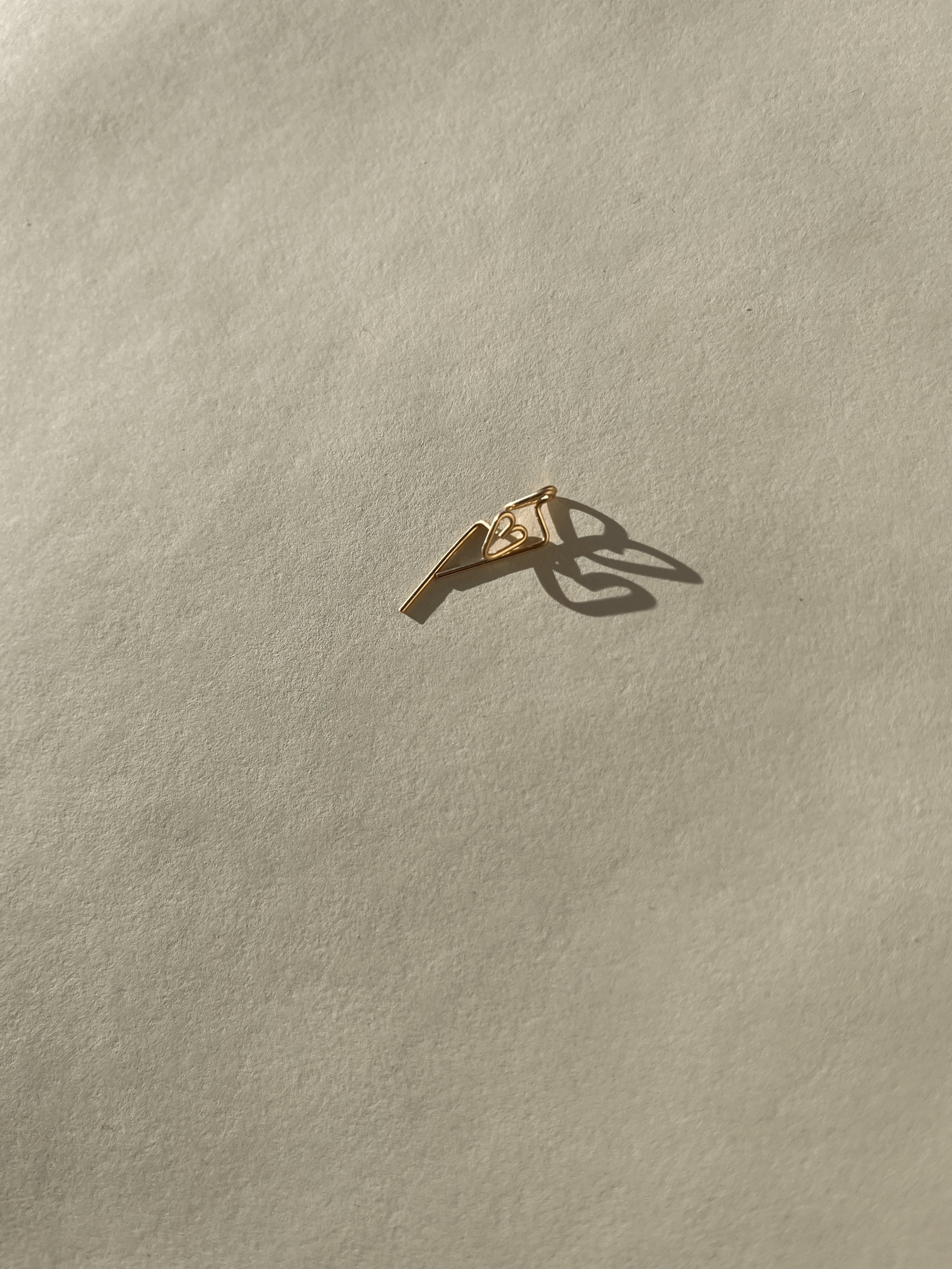 Petite Heart Drop-Back Earrings displayed on a neutral background, featuring a minimalist heart front and the drop-back post in gold-filled