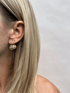 Model wearing yellow gold-filled sand dollar threader earrings in both ears, 12mm in the first piercing and 10mm in the second
