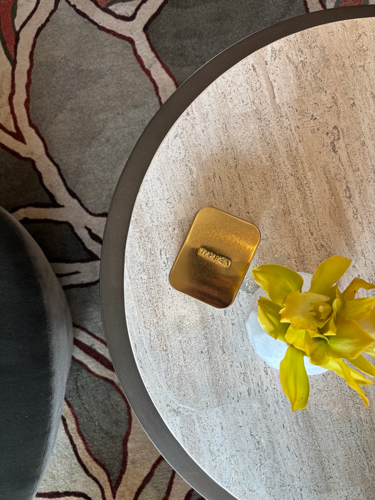 gold THALKEN card case on table in hotel lobby