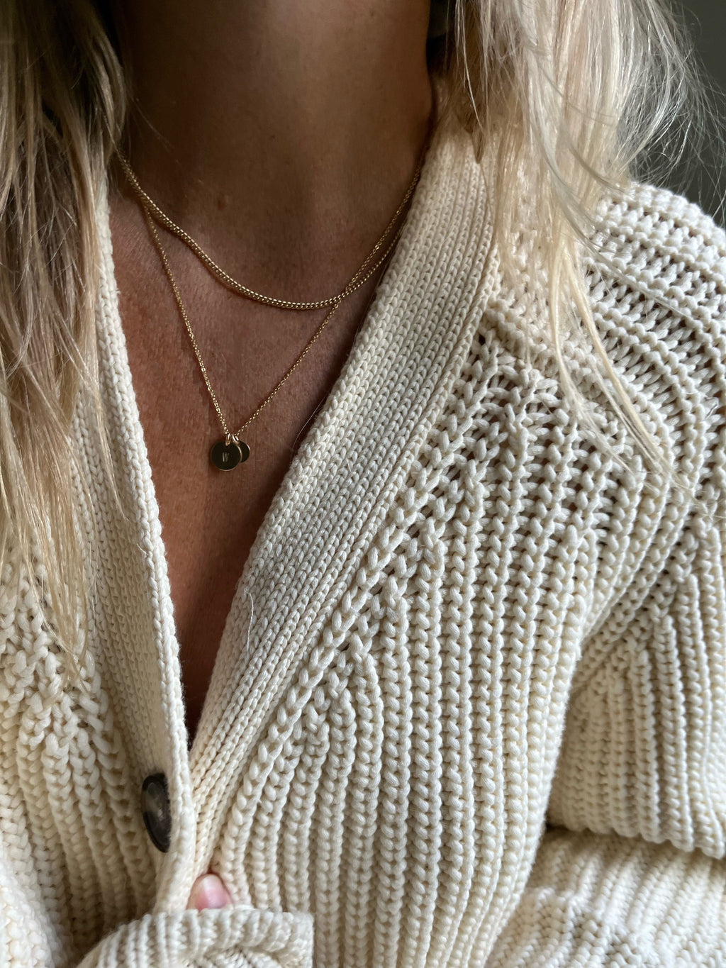 Model wearing an 18” yellow gold-filled Stamped Letter Charm Necklace with 7mm and 9mm gold-filled disc charms, layered with a 16” gold-filled curb chain