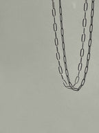 Sterling silver medium link paperclip necklace suspended in air, highlighting the elongated links