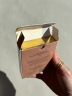 Thalken Heart Questions Volume 2 deck inside its dusty rose box, with the gold-gilded edges visible and the yellow heart design on display