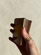 Angled view of Thalken Heart Questions Volume 2 cards highlighting the shimmering gold-gilded edges