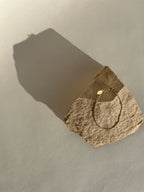 Thalken Perfect Curb Chain Bracelet in Yellow Gold-filled displayed on a rock in warm light, straight on