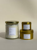 Photo of Thalken’s Zen Baby candle shown in three vessel options — sleek gold tins (2oz and 6oz) and a soft-glow glass jar (8oz). Bright and sunny scent profile with notes of citrus, cucumber, and bamboo.